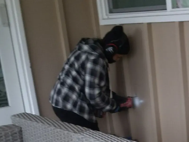 Professional electrician installing an exterior outlet in Armada
